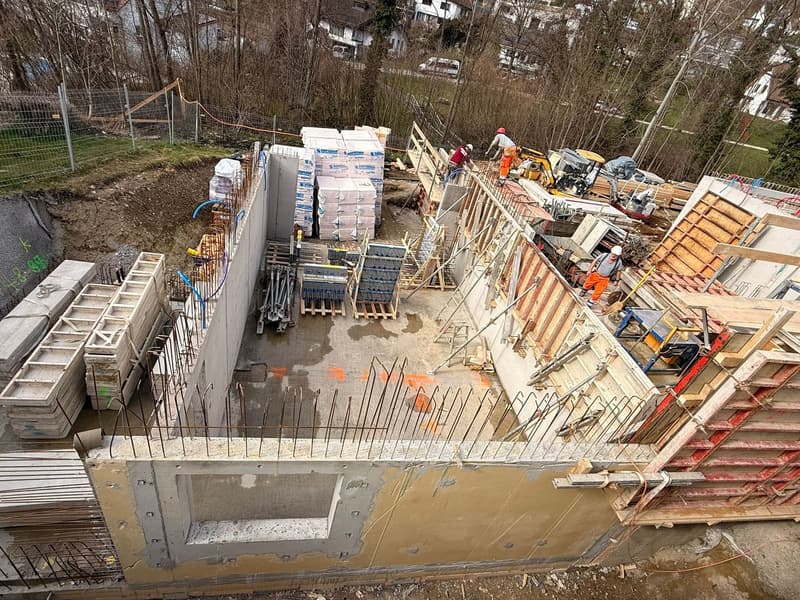 Under construction building, concrete foundation, steel reinforcement, workers, construction materials
