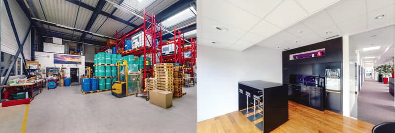 The image shows a large industrial warehouse space with high ceilings, red metal shelving units, and various storage containers and pallets. The other part of the image shows a modern office space with a kitchen area, wooden flooring, and black furniture.