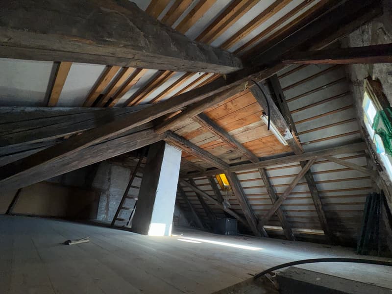 attic room, wooden ceiling beams, wooden floor, ladder to other floor