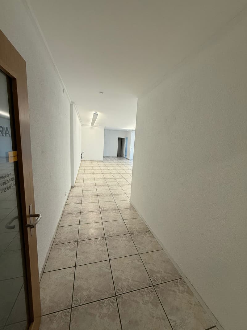 tiled floor, white walls, ceiling lights, doorway, glass door