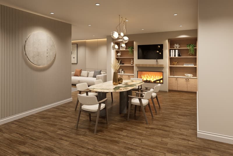 Dining room with a large oval table, fireplace, and a couch in the background