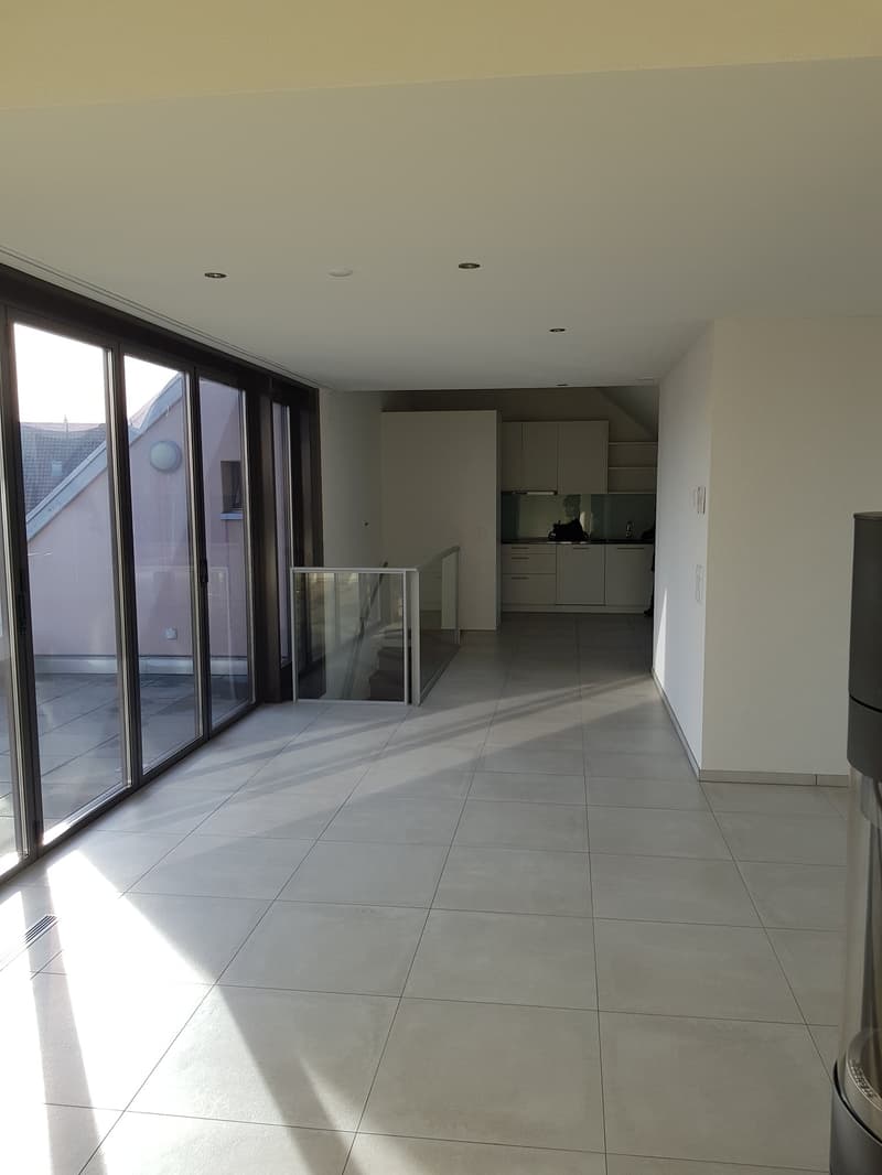Empty room, white tiles, large glass doors, glass railing, white kitchen, white cabinets, white walls