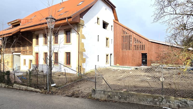 Newly constructed, 2 story house, red roof, wooden wall, window with white frame, under construction