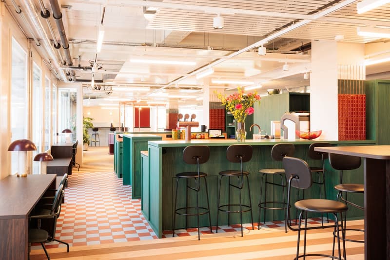 Modern, open-concept kitchen with a large island, colorful decor, and bar seating. The kitchen features a dishwasher and various kitchen appliances and decor elements.