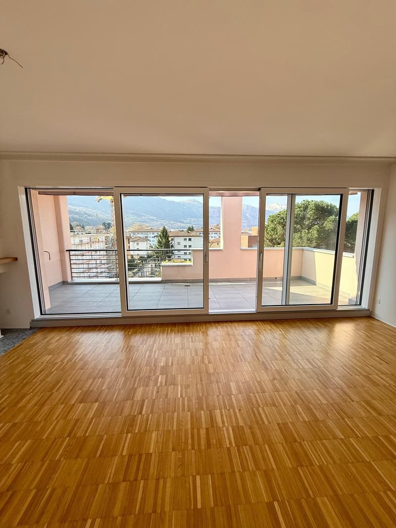 empty room, wooden floor, large sliding glass doors, balcony, mountain view