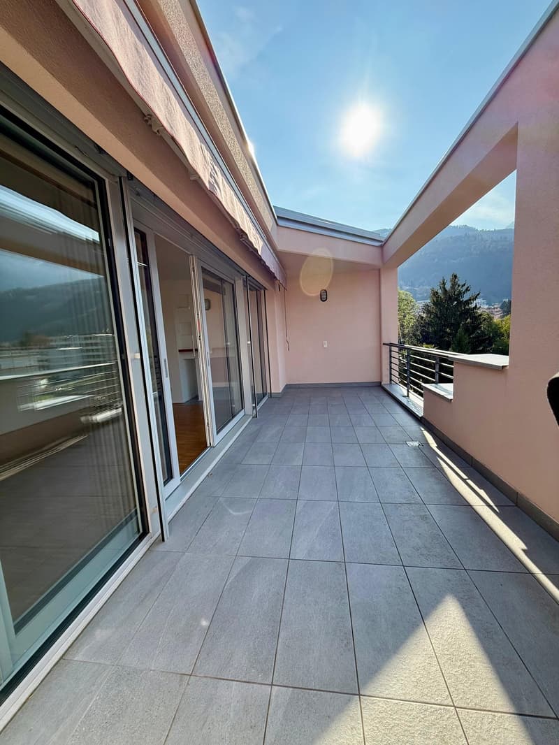 large balcony, glass doors, tiled floor, metal railing, view of mountains