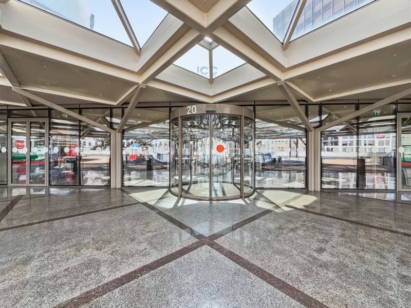 modern building, glass walls, revolving door, marble floor, glass ceiling