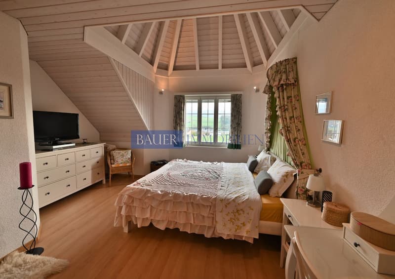 Bedroom with a bed, drawers, chair, curtains, tv, lamp, rug, carpet, pictures on the wall
