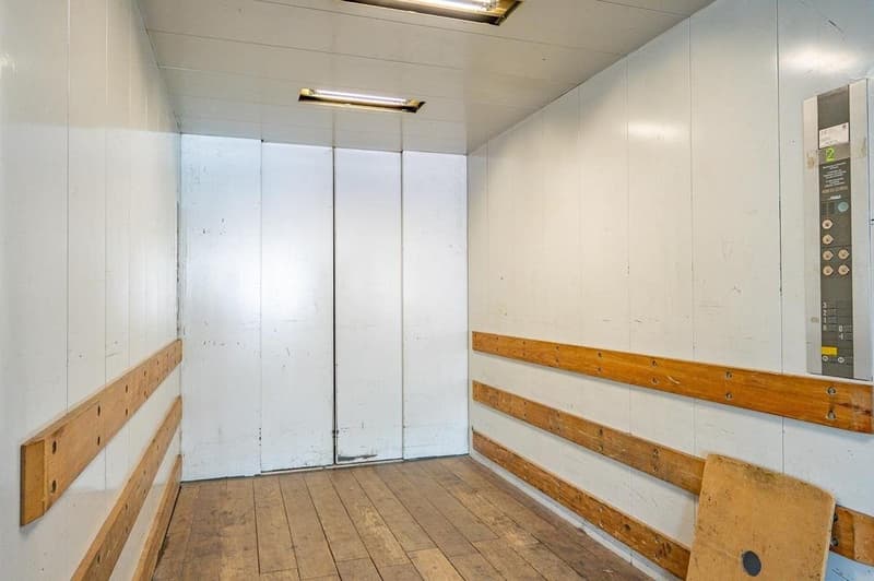 wooden floor, white walls, elevator, panel with buttons