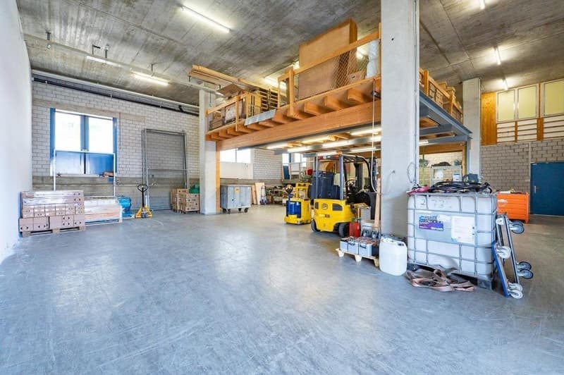 spacious warehouse, concrete floor, wooden mezzanine, industrial shelving, forklifts, storage boxes, window, door