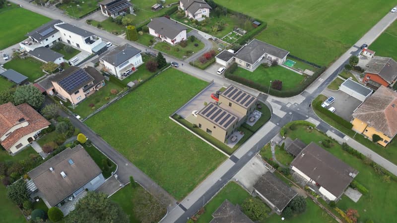 modern suburban houses, with solar panels, raised ground floor, swimming pool, gardens, grass fields