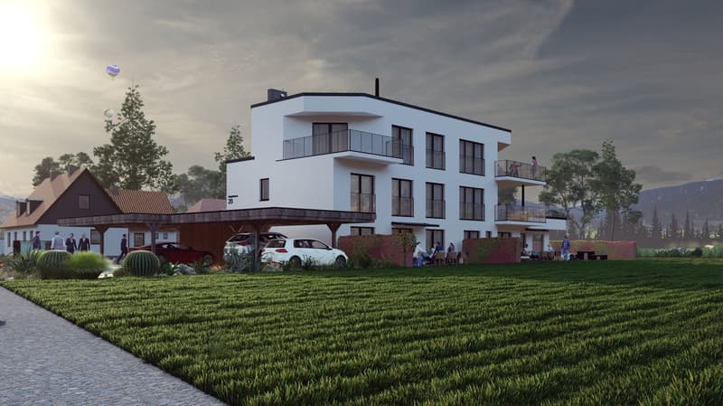 3-story modern apartment building with white exterior, balconies, and parking spaces in front of the building. The building is surrounded by a grassy area with trees and shrubs.