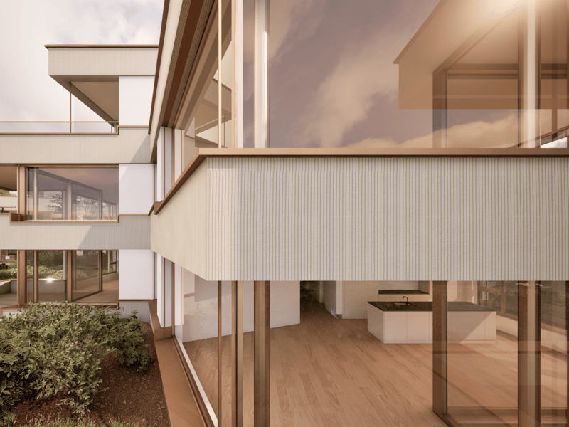 Modern two-story house with large windows, wooden accents, and a balcony or terrace. The interior features an open floor plan with a kitchen and living area visible through the glass walls.
