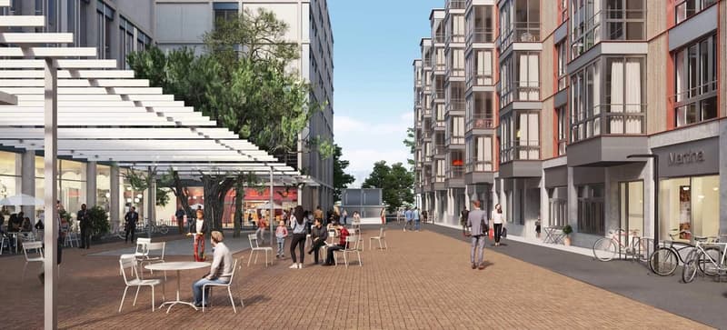 Pedestrian-friendly street with outdoor seating, shops, and residential buildings with balconies
