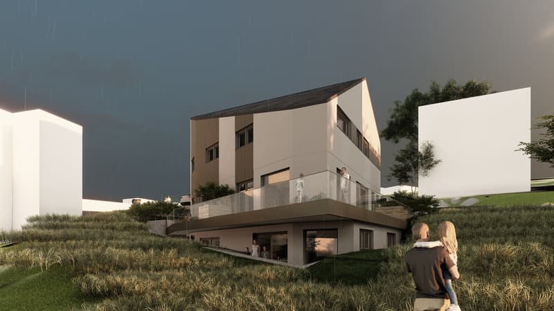 Two-story modern house with a flat roof, large windows, and a balcony on the second floor. The house is surrounded by a grassy area and trees.