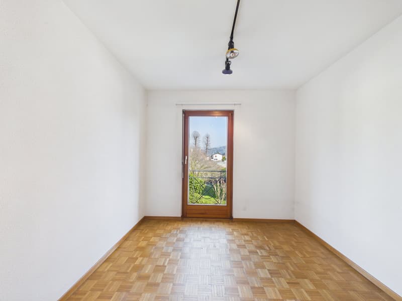empty room, white walls, wooden floor, wooden door, window with balcony, hanging light