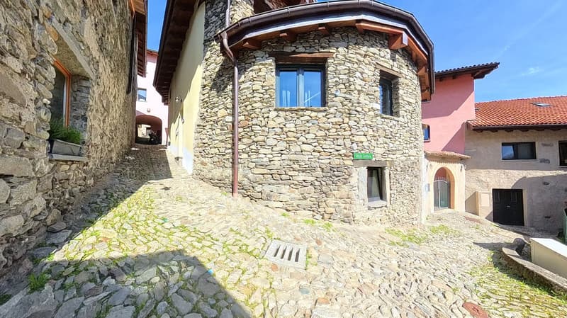 Stone building, red roof, windows, street, plants