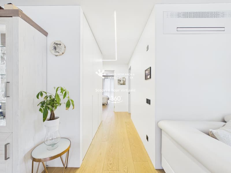 modern interior, white walls, wooden floor, white couch, plant, glass table, white cabinet