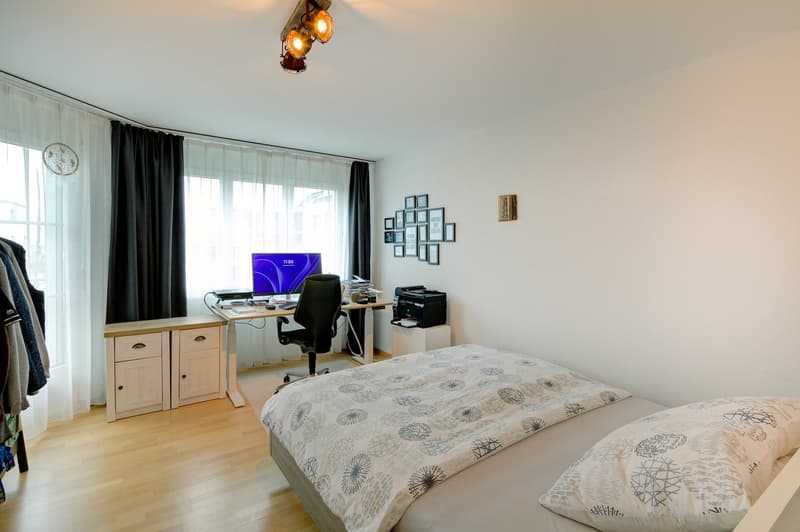 Bed, desk, computer monitor, printer, chair, cabinets, lamp, framed pictures, clock, curtains