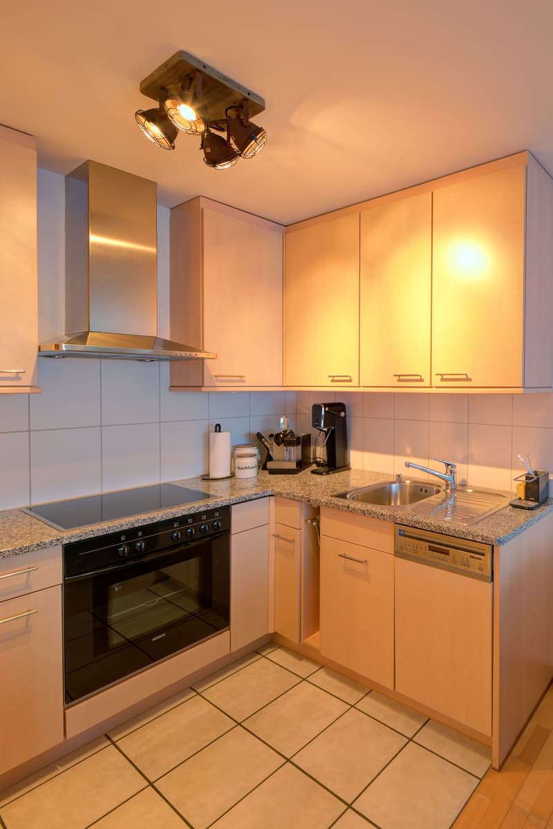 kitchen, gas stove, oven, sink, faucet, countertop, cabinets, dishwasher, coffee machine, roll holder, tile flooring