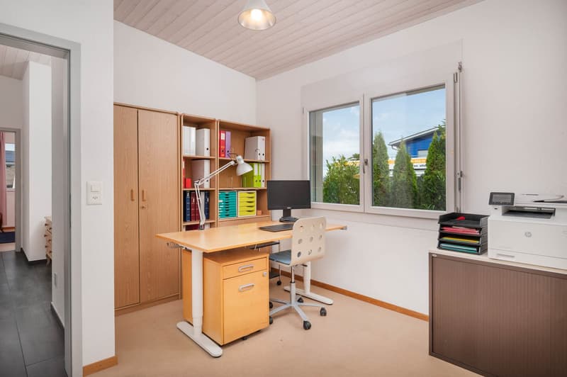 wooden desk with drawers, office chair, computer monitor, lamp, shelves, printer