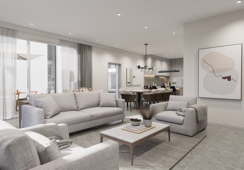 Spacious open-concept living room and dining area, with large windows, grey sofas, coffee table, and modern artwork on the wall. The kitchen is visible in the background.