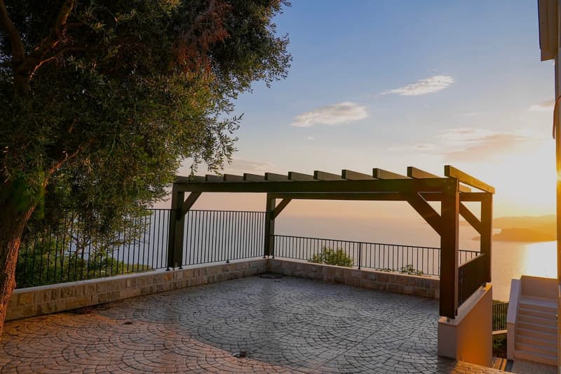 brick paved terrace, pergola with metal railings, ocean view