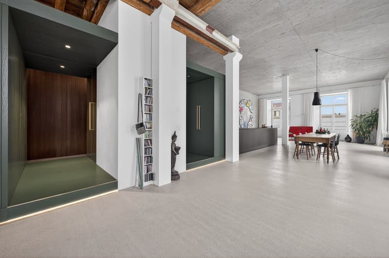 Exposed beams, modern minimalist design, white and green walls, industrial wooden door, open living and dining area, table, chairs, open shelf, Buddha statue, pendant light, artwork on wall