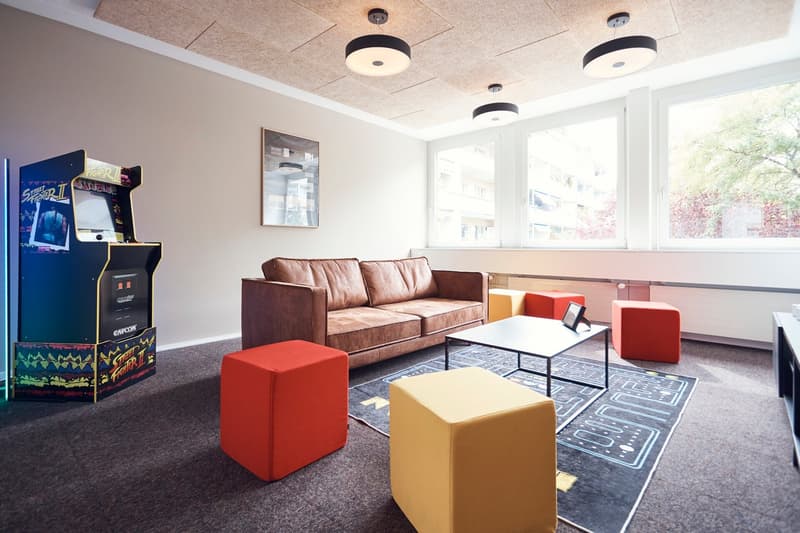leather couch, coffee table, carpet, gaming arcade, red stools, picture
