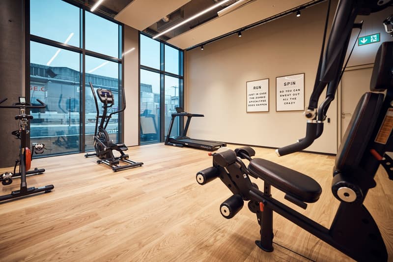 a gym room with a treadmill, exercise bike, elliptical machine, and weight machine