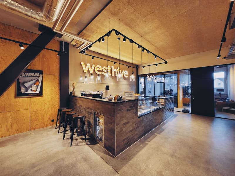 modern bar area with wooden counter, brick backsplash, stools, lamps, open windows, decorative elements