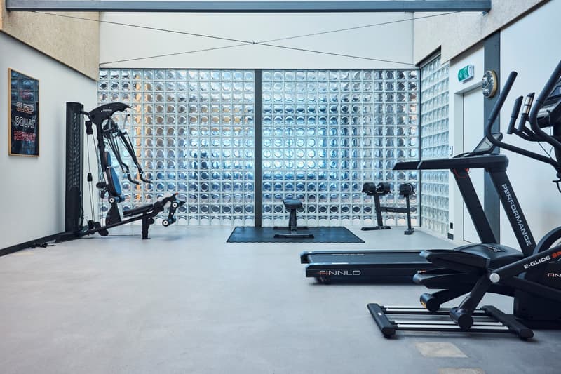 modern gym, various gym equipment, glass wall, workout sign