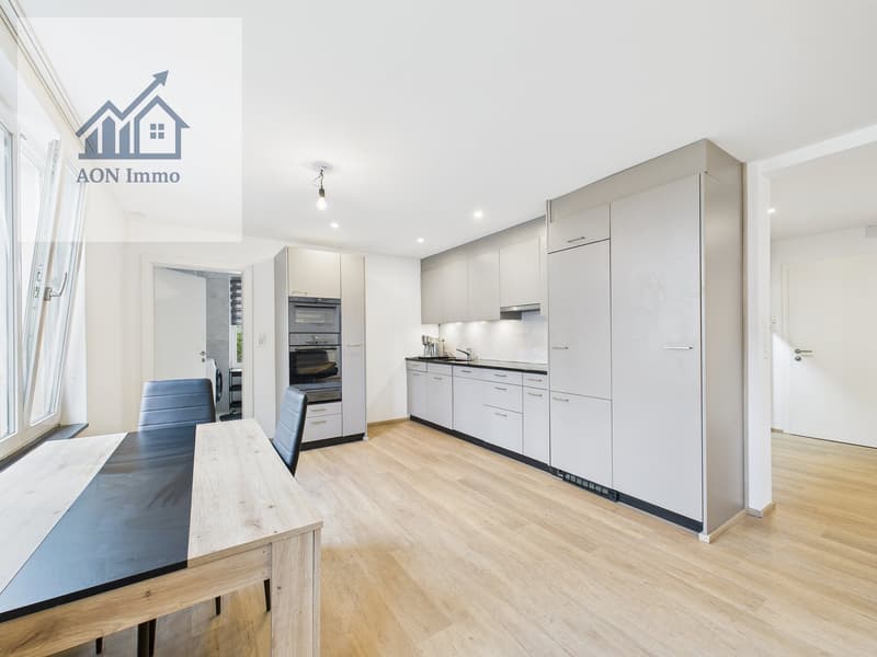 modern kitchen with wooden floor, white cabinets, black dining table, blue chairs, large windows, oven, sink, faucet