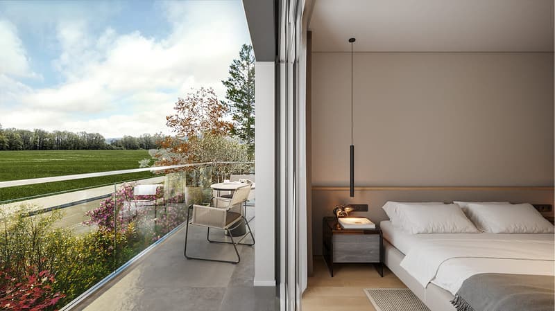bedroom with bed, night table, balcony with chairs and table