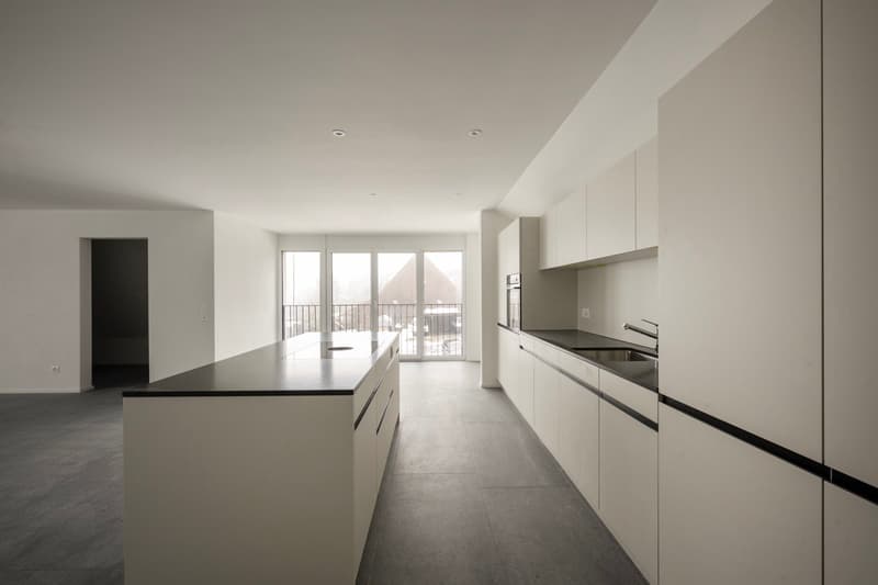 modern minimalist kitchen, white cabinets, gray floors, central island, balcony, large windows