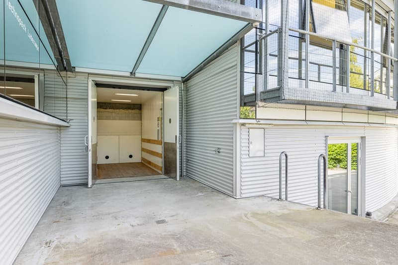 building with steel walls and metal ramps, doors leading to indoor parking