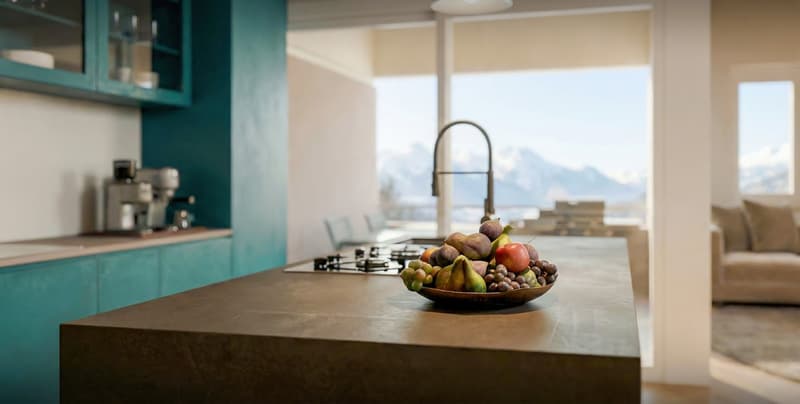 kitchen with island, teal cabinets, granite countertop, gas stove, faucet, bowl of fruit, large windows, view of mountains