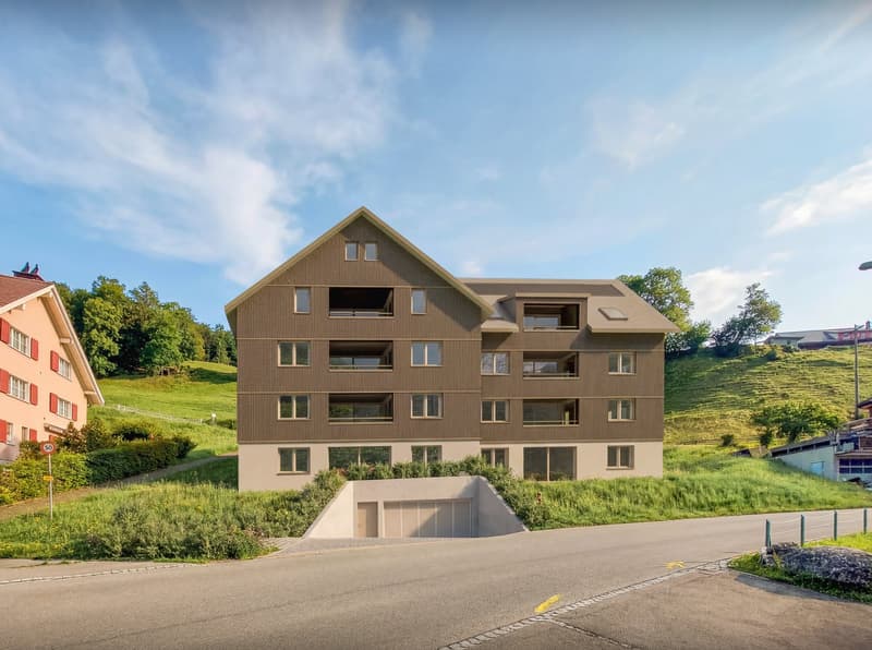 Modern apartment building, brown exterior, multiple windows, underground garage, set on a hillside