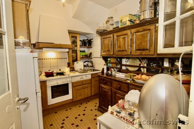 White appliances, wooden cabinets, checkered tiles, open shelves