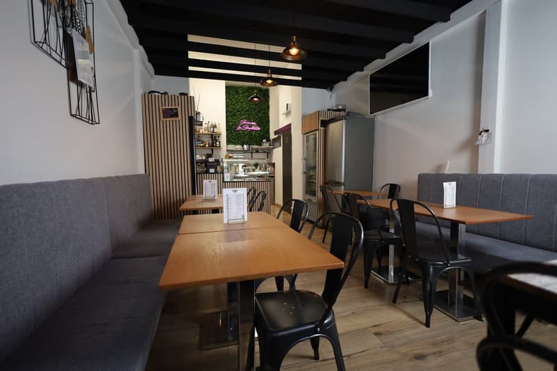 cafe interior with tables, chairs, and seating area with a counter