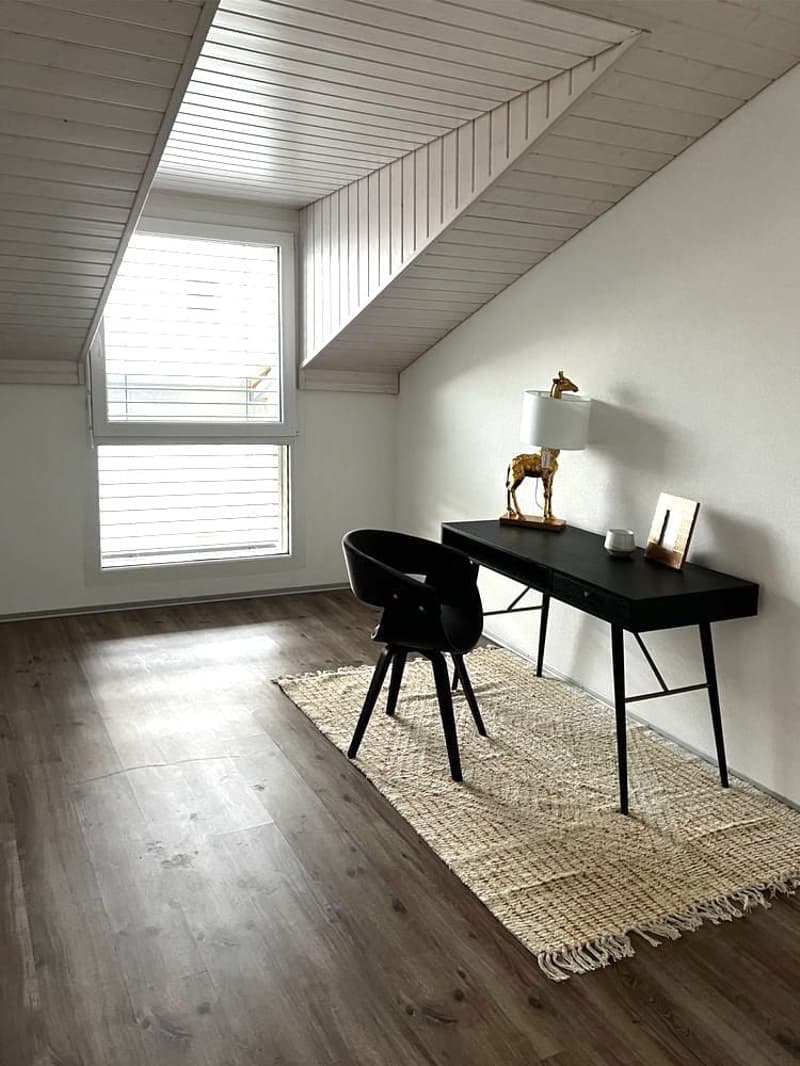 wooden floor, white ceiling, desk, chair, lamp, picture frame, window