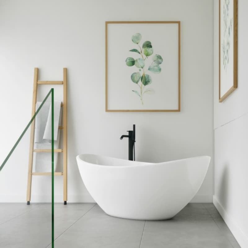 white bathtub, black faucet, wooden towel rack, framed picture on the wall, gray tiles