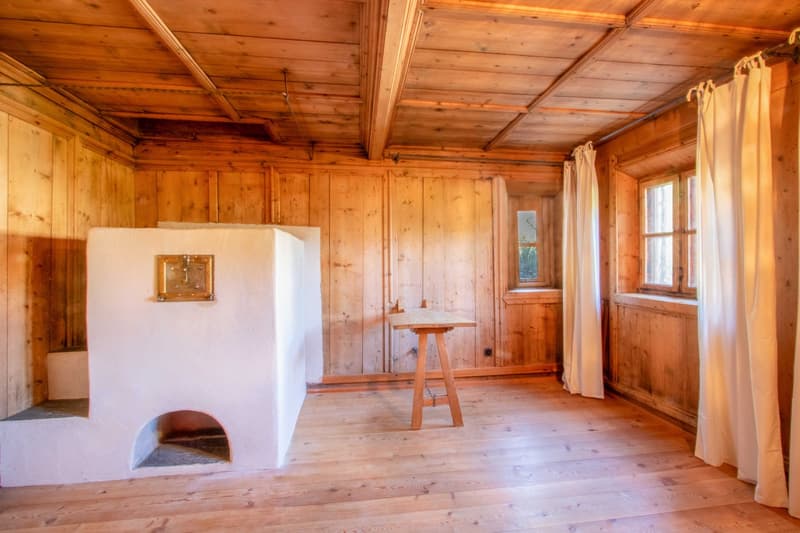 Wooden room, fireplace, wooden table, windows with curtains, wooden floor