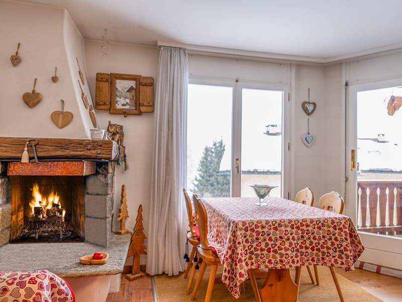Fireplace, dining table, chairs, glass doors, balcony