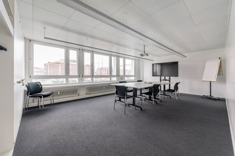 empty room, long table, chairs, projector, whiteboard, windows