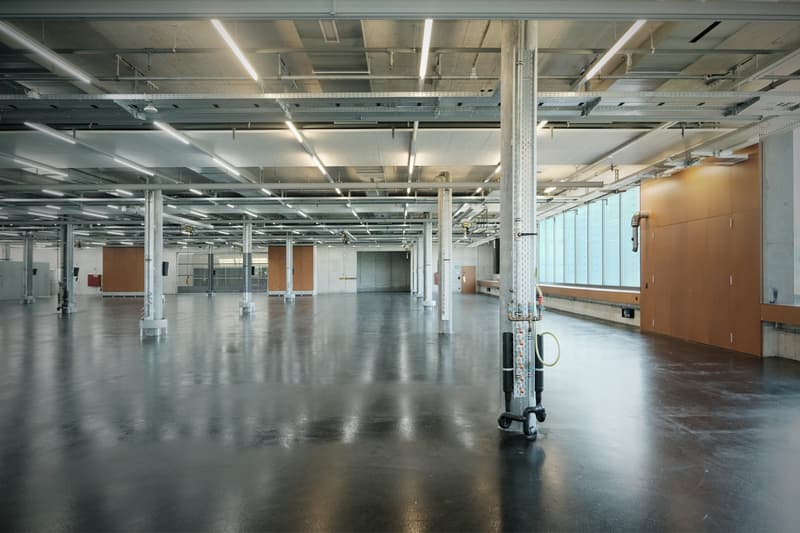 empty large warehouse, white ceiling, wooden walls, large windows, industrial equipment