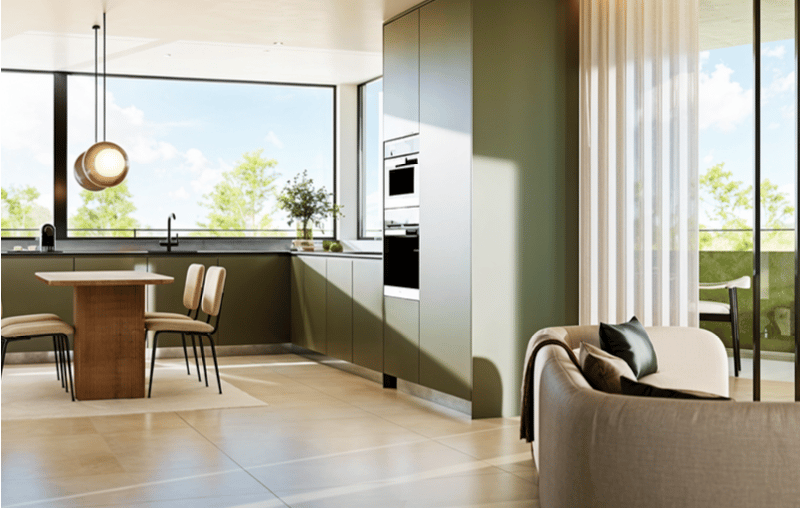 Open-plan kitchen with modern appliances, dining area with wooden table and chairs, living area with a couch, large windows