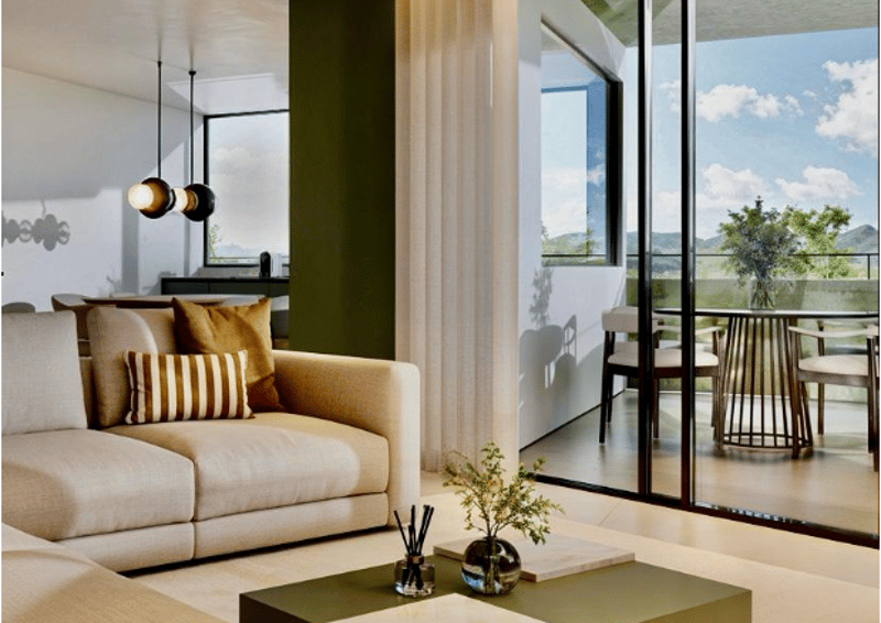 large L-shaped couch, wooden table with plants, double doors leading to terrace, window
