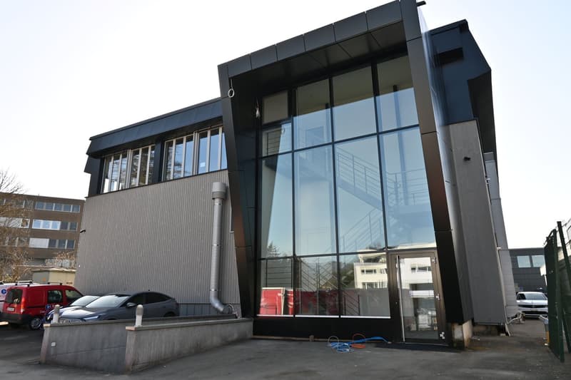 modern design, large windows, entrance, cars parked in front