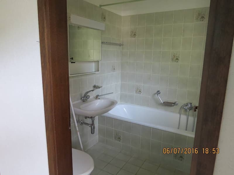 Bathroom with a bathtub, sink, and toilet.